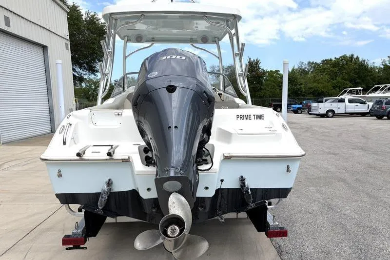 Slide: The Image of 2024 Key West 239 DFS boat with powerful outboard motor, parked outdoors. - 11