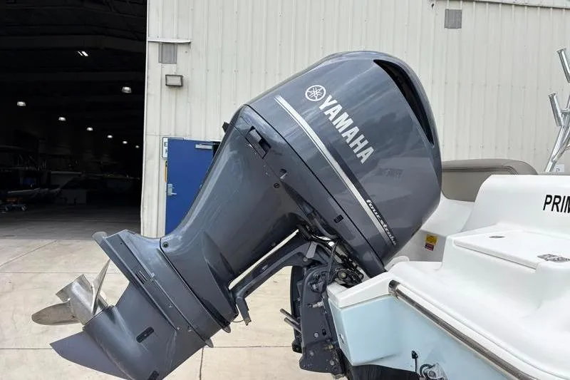 Slide: The Image of 2024 Key West 239 DFS boat with Yamaha outboard motor in a marina setting. - 12