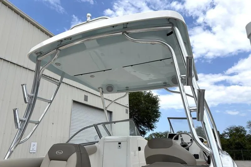 Slide: The Image of 2024 Key West 239 DFS boat with sleek design and sturdy T-top under a blue sky. - 13