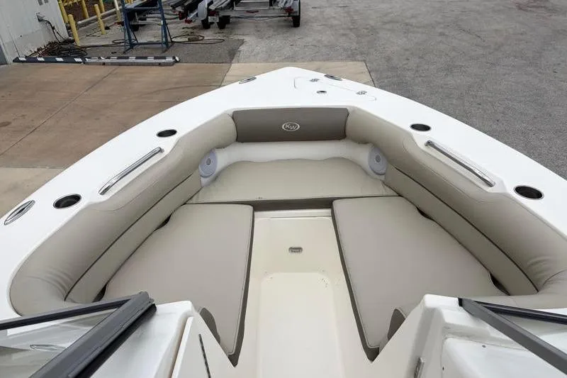 Slide: The Image of 2024 Key West 239 DFS boat interior with cushioned seating and cup holders. - 16