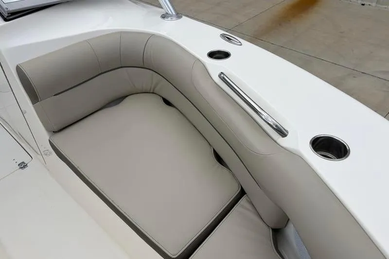 Slide: The Image of 2024 Key West 239 DFS boat interior with cushioned seating and cup holders. - 19