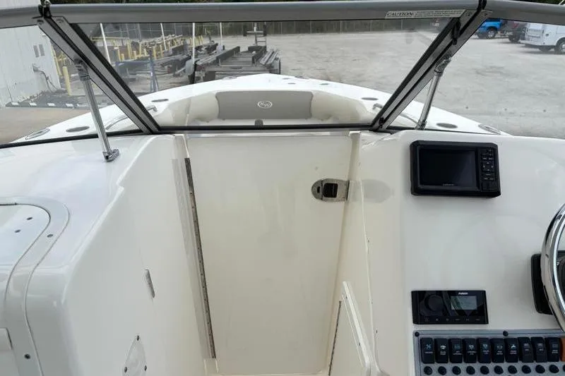 Slide: The Image of 2024 Key West 239 DFS boat dashboard with navigation controls and windshield. - 21
