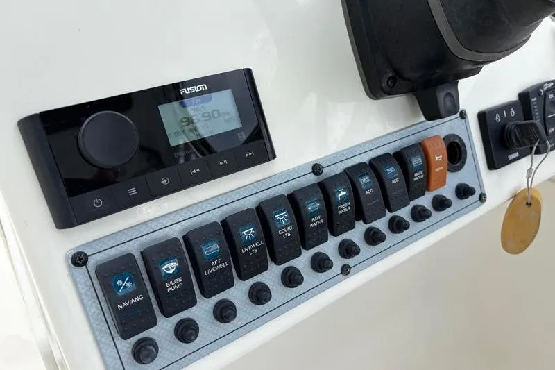 Slide: The Image of 2024 Key West 239 DFS boat dashboard with control panel and Fusion audio system. - 25