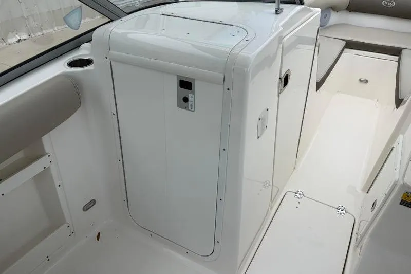 Slide: The Image of 2024 Key West 239 DFS boat interior with white seating and storage compartment. - 27