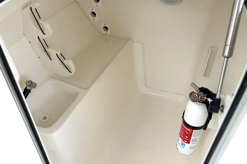 Slide: The Image of Interior of 2024 Key West 239 DFS boat with fire extinguisher and storage space. - 28