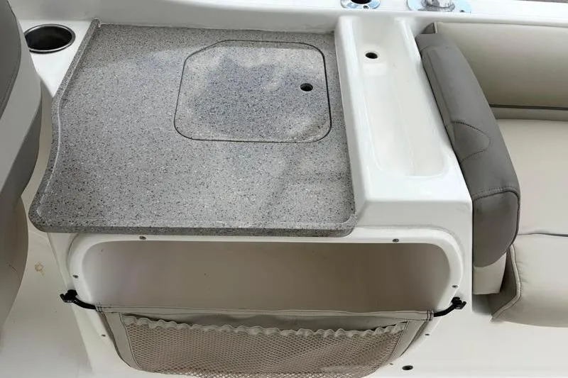 Slide: The Image of 2024 Key West 239 DFS boat interior with storage compartment and seating area. - 32