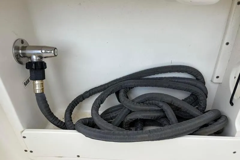 Slide: The Image of Coiled hose in 2024 Key West 239 DFS boat compartment. - 35