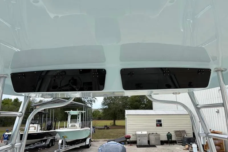 Slide: The Image of 2024 Key West 239 DFS boat interior view with overhead compartments and outdoor setting. - 39