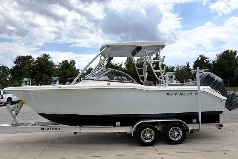 Slide: The Image of 2024 Key West 239 DFS boat on trailer under cloudy sky. - 4