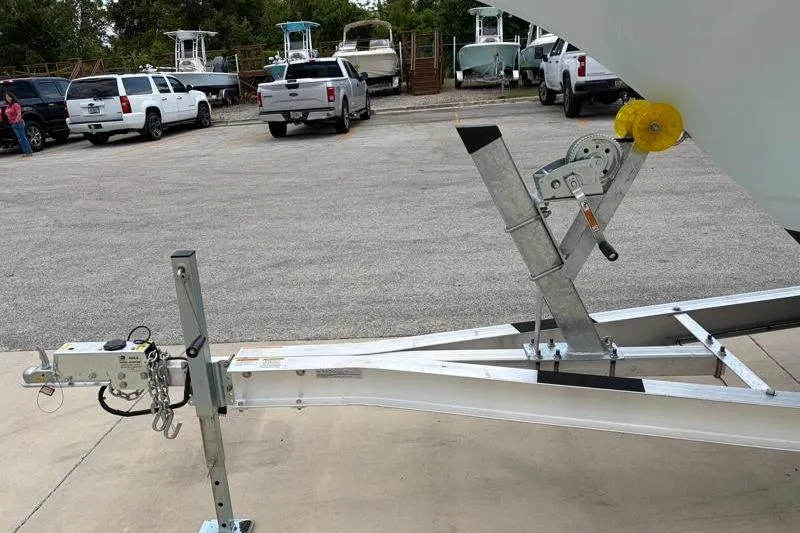 Slide: The Image of Trailer for 2024 Key West 239 DFS boat in parking lot with trucks and boats. - 40