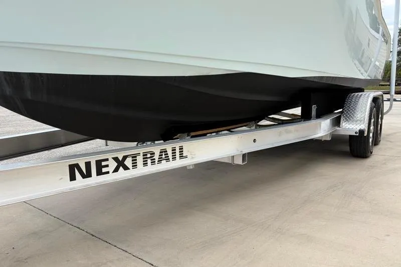 Slide: The Image of 2024 Key West 239 DFS boat on NexTrail trailer, parked on concrete surface. - 41