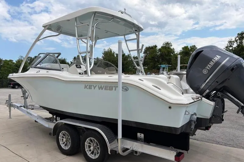 Slide: The Image of 2024 Key West 239 DFS boat on trailer with Yamaha engine, parked outdoors. - 5