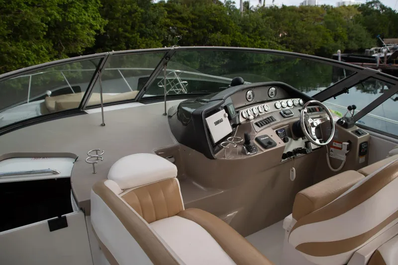 Slide: The Image of 2005 Four Winns 378 Vista boat cockpit with modern controls and comfortable seating. - 16