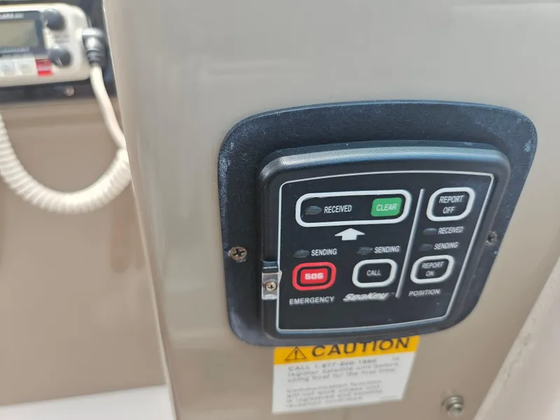 Slide: The Image of Control panel on a 2005 Four Winns 378 Vista boat, featuring emergency and communication buttons. - 27