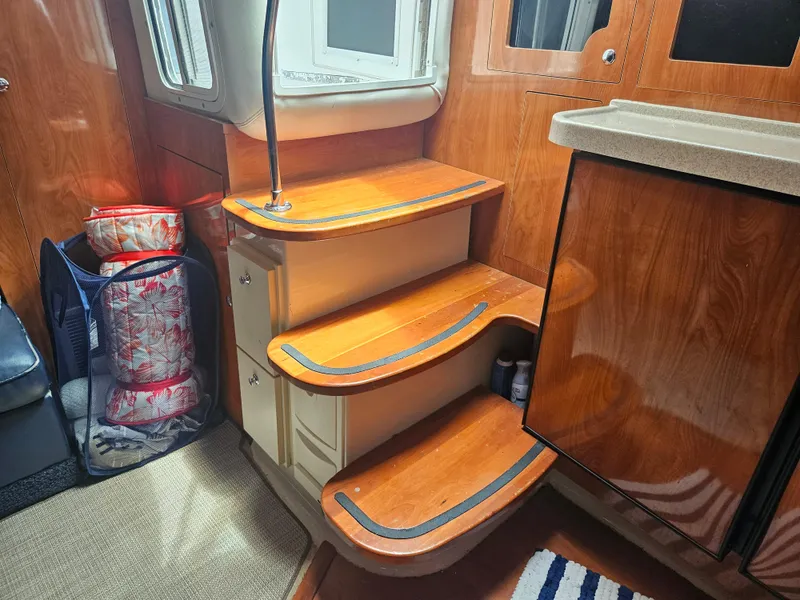 Slide: The Image of Interior of 2005 Four Winns 378 Vista yacht with wooden steps and storage. - 28