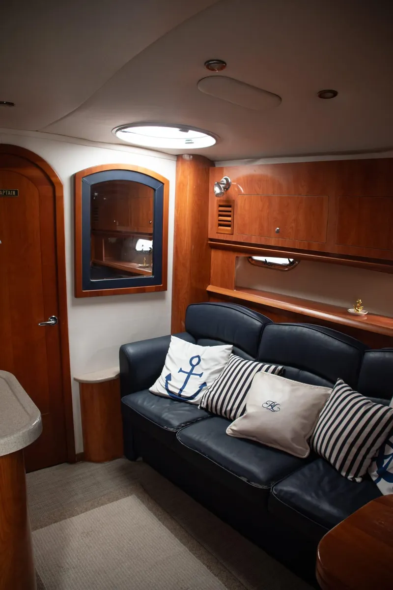 Slide: The Image of Interior of 2005 Four Winns 378 Vista yacht with leather seating and nautical-themed pillows. - 32