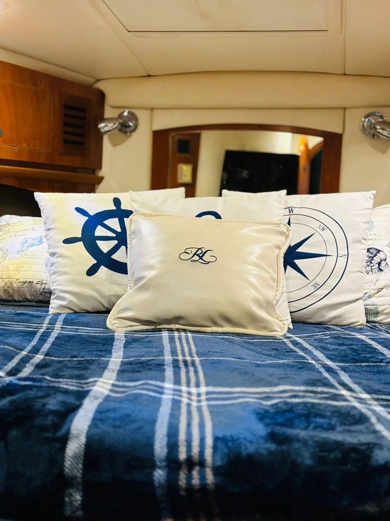 Slide: The Image of 2005 Four Winns 378 Vista cabin with nautical-themed bedding and decorative pillows. - 39