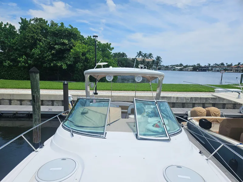 Slide: The Image of 2005 Four Winns 378 Vista boat docked by a scenic waterfront. - 7