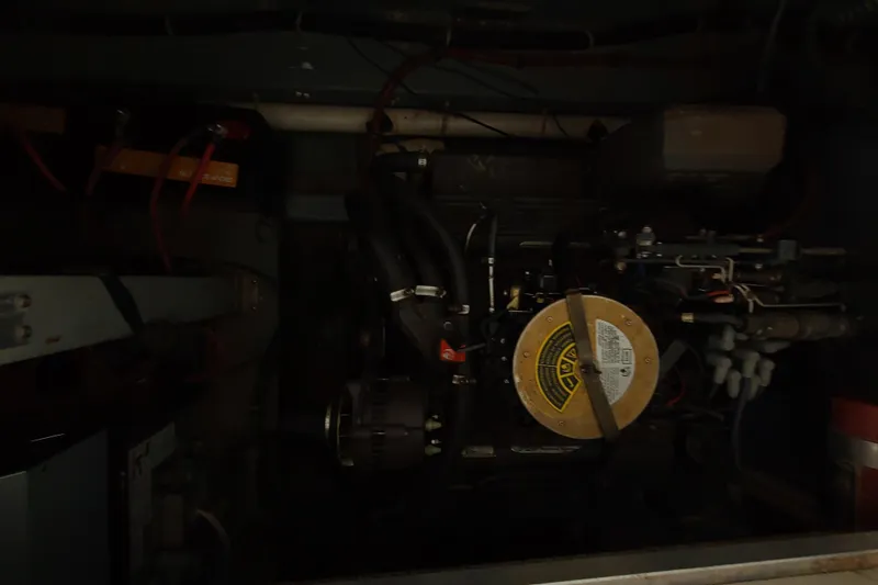 Slide: The Image of Engine compartment of a 1987 Sea Ray 300 Sundancer boat, showcasing mechanical components. - 10