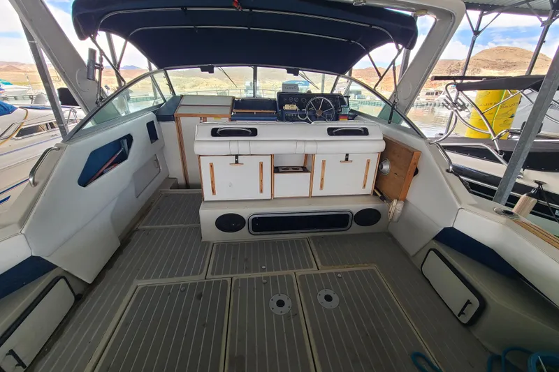 Slide: The Image of 1987 Sea Ray 300 Sundancer boat interior with helm, seating, and covered cockpit. - 5