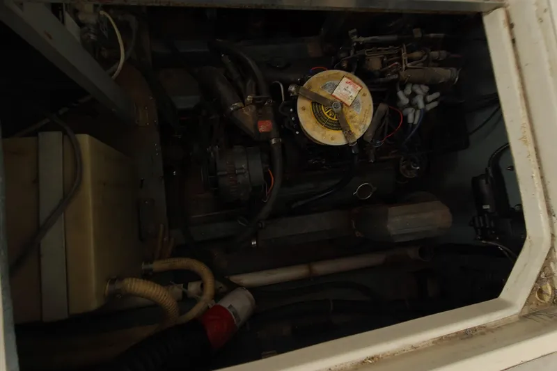 Slide: The Image of Engine compartment of a 1987 Sea Ray 300 Sundancer boat, showcasing mechanical components. - 9