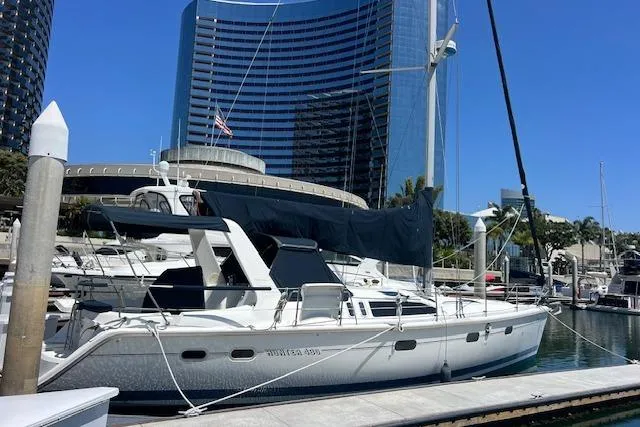 The Image of Sailboat docked in marina, Hunter 430 model, 1997, with modern buildings in background. - 1