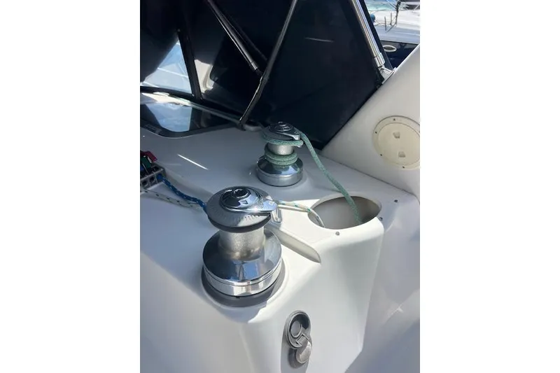 Slide: The Image of Winches on a 1997 Hunter 430 sailboat deck, with ropes and fittings visible. - 16