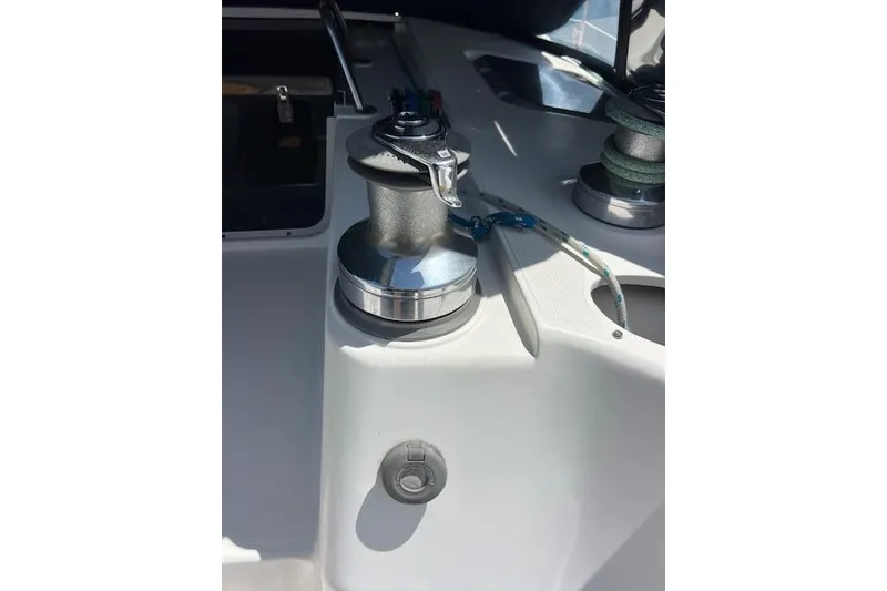 Slide: The Image of Winch on 1997 Hunter 430 sailboat deck, featuring rope and handle. - 18