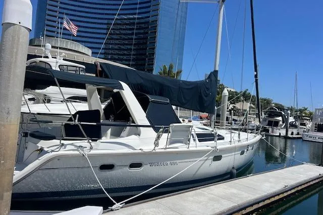 Slide: The Image of Sailboat docked at marina, 1997 Hunter 430 model, with cityscape background. - 2