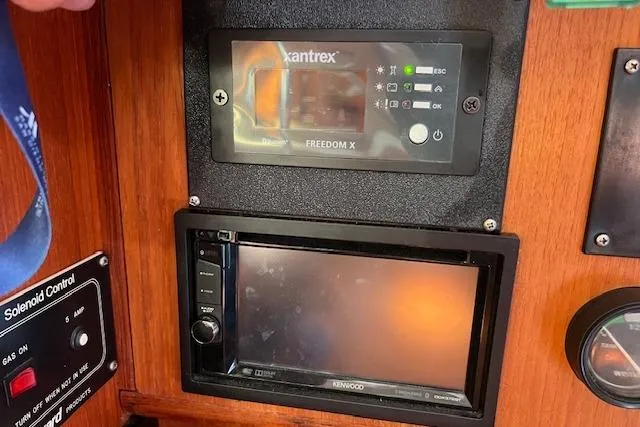 Slide: The Image of Control panel of a 1997 Hunter 430 sailboat with Xantrex and Kenwood devices. - 23
