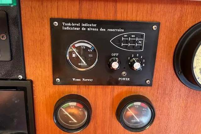 Slide: The Image of Tank-level indicator panel on a 1997 Hunter 430 boat dashboard. - 24