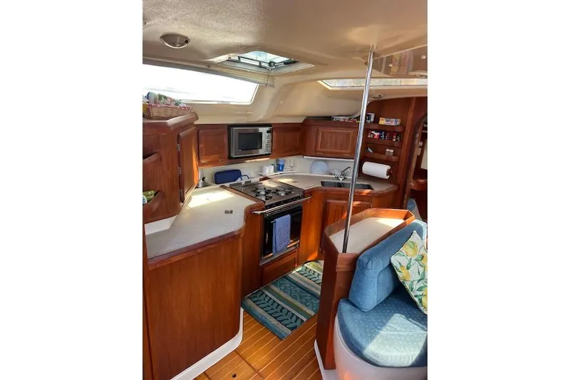 Slide: The Image of Interior of 1997 Hunter 430 yacht with kitchen and seating area. - 26