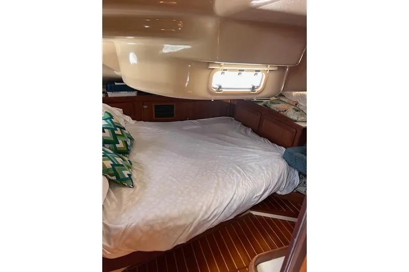Slide: The Image of Cozy cabin interior of 1997 Hunter 430 sailboat with bed and porthole window. - 31