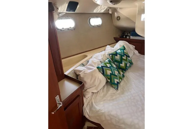Slide: The Image of Cozy cabin interior of 1997 Hunter 430 sailboat with patterned pillows. - 33