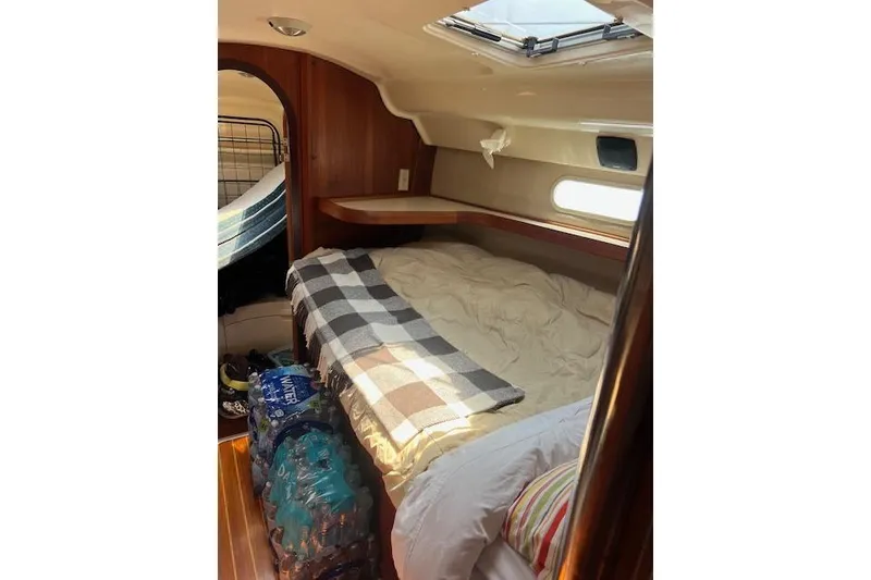 Slide: The Image of Cozy cabin interior of a 1997 Hunter 430 sailboat with bed and supplies. - 34
