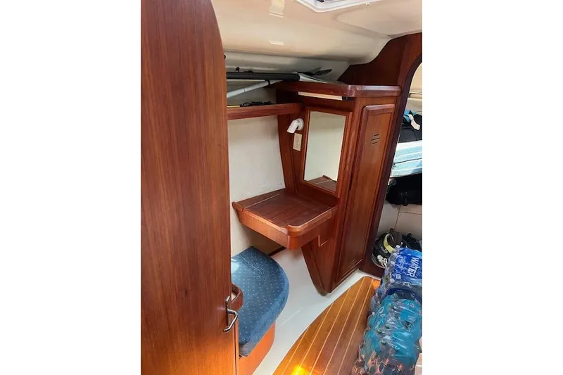 Slide: The Image of Interior of a 1997 Hunter 430 sailboat with wooden cabinetry and seating. - 35