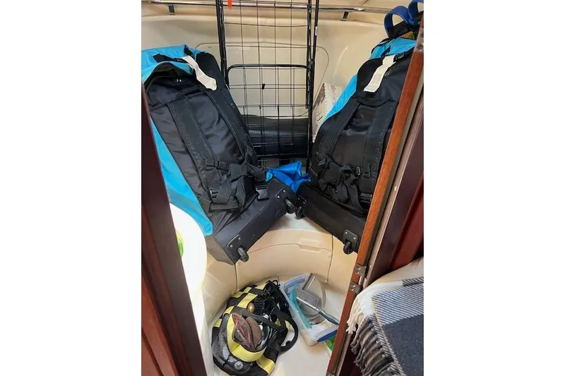 Slide: The Image of Interior of a 1997 Hunter 430 sailboat with backpacks and gear storage. - 36