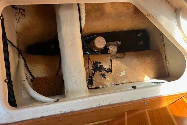 Slide: The Image of Interior view of a 1997 Hunter 430 sailboat showing storage compartment details. - 37