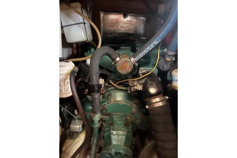 Slide: The Image of Engine compartment of a 1997 Hunter 430 sailboat, showing hoses and components. - 40