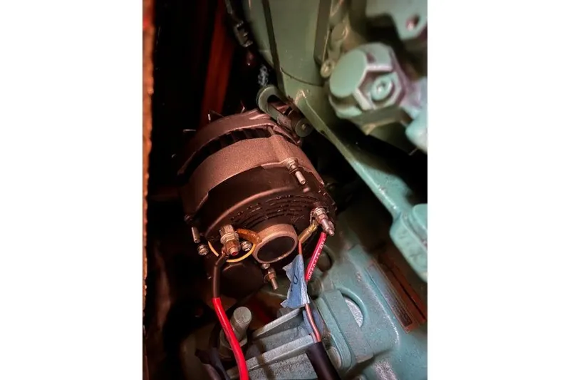 Slide: The Image of Close-up of a 1997 Hunter 430 engine component with visible wiring and bolts. - 42