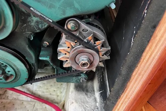 Slide: The Image of Engine component of a 1997 Hunter 430 sailboat, featuring a belt-driven alternator. - 45