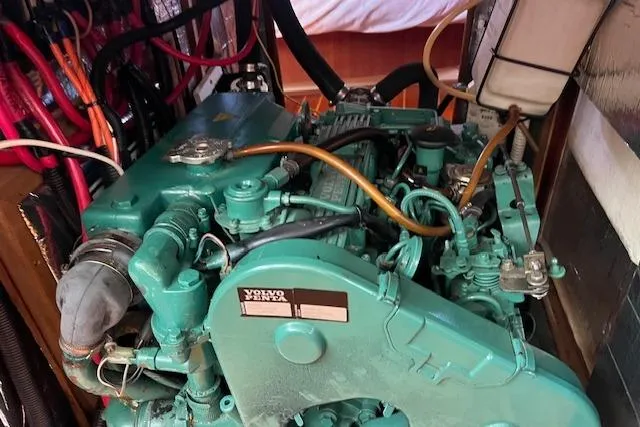 Slide: The Image of Volvo Penta engine in a 1997 Hunter 430 sailboat, showcasing intricate wiring and components. - 46