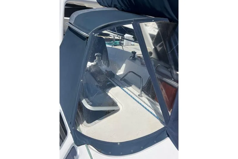 Slide: The Image of 1997 Hunter 430 sailboat cockpit with protective canopy and clear windows. - 53