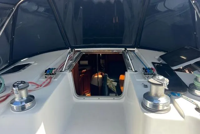 Slide: The Image of 1997 Hunter 430 sailboat deck with open hatch and winches. - 54