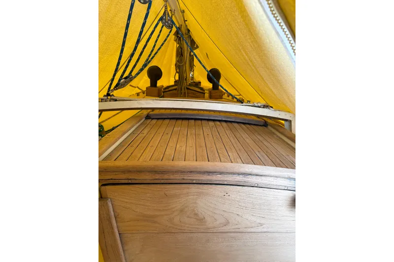Slide: The Image of Interior view of a 1978 Pacific Seacraft 31 sailboat with yellow canopy and wooden deck. - 10