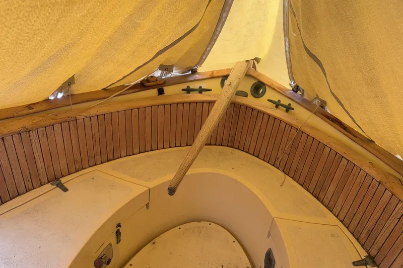 Slide: The Image of Interior view of a 1978 Pacific Seacraft 31 sailboat cabin with wooden accents. - 13