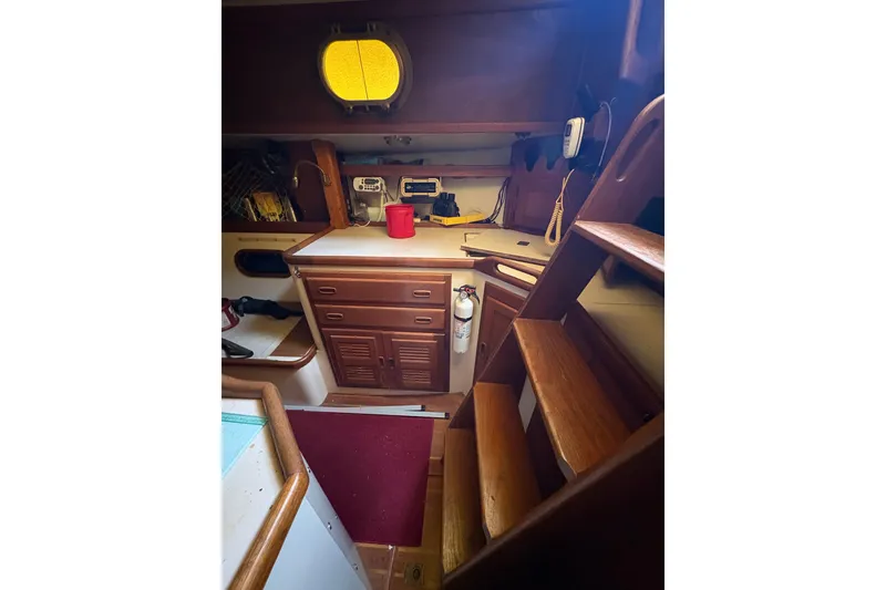 Slide: The Image of Interior of 1978 Pacific Seacraft 31 sailboat with wooden cabinetry and stairs. - 15