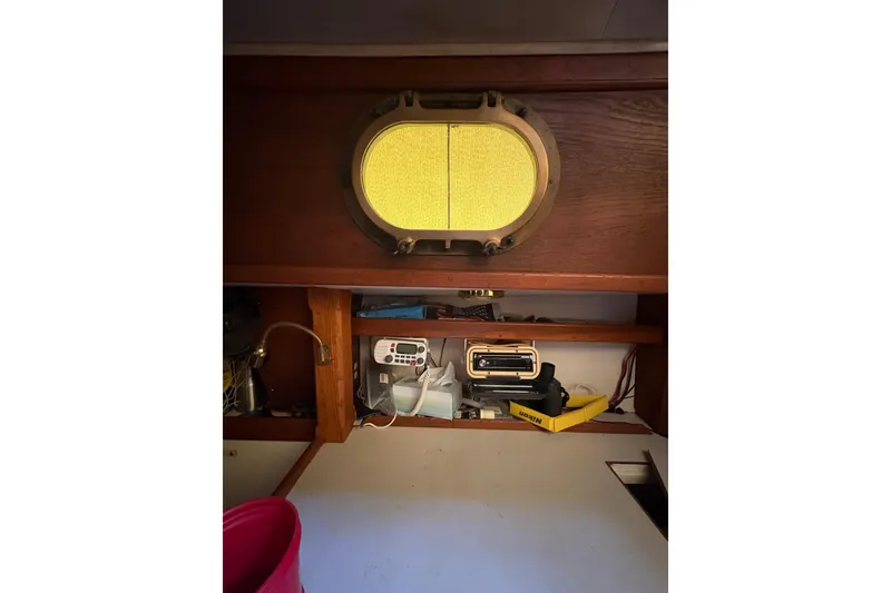 Slide: The Image of Interior of 1978 Pacific Seacraft 31 sailboat with porthole and storage shelves. - 17