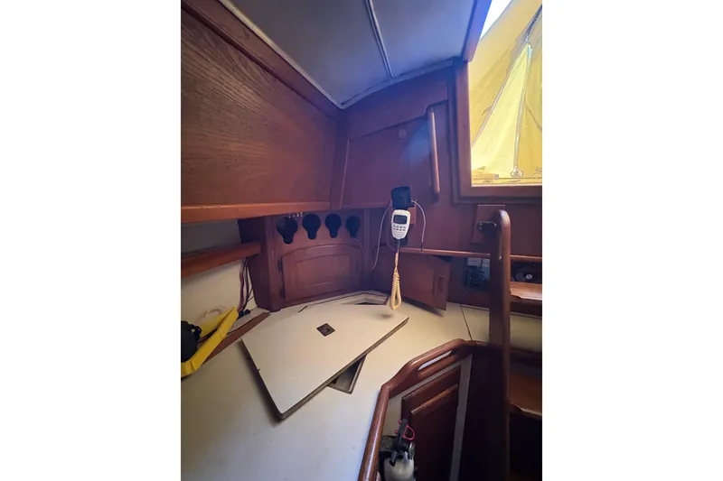 Slide: The Image of Interior of 1978 Pacific Seacraft 31 sailboat with wooden cabinetry and communication equipment. - 22