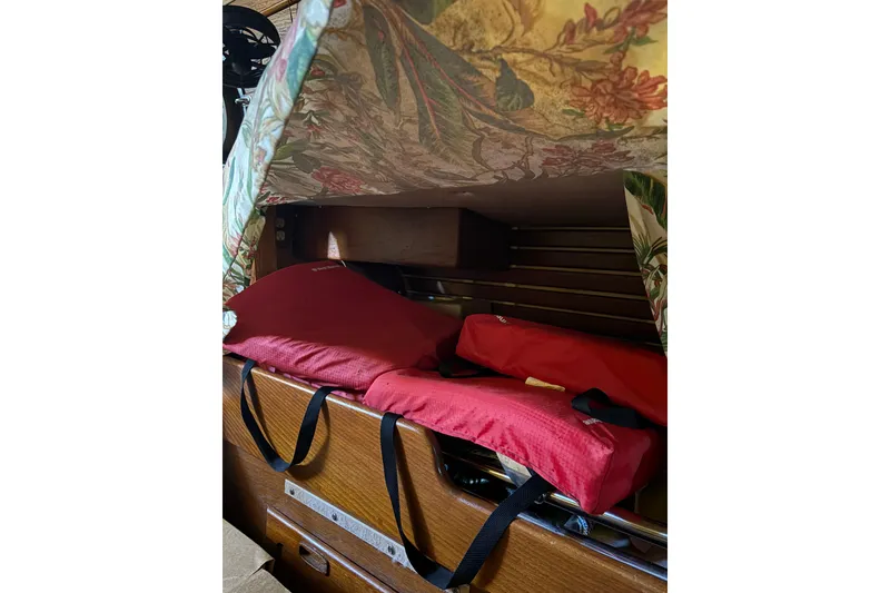 Slide: The Image of Interior of 1978 Pacific Seacraft 31 with red life jackets and floral fabric cover. - 29
